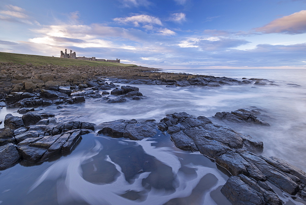 Rocky shores below Dunstanburgh Castle, Craster, Northumberland, England, United Kingdom, Europe