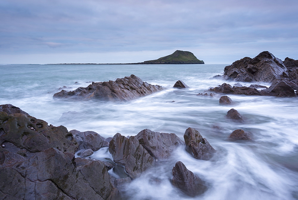 Rocky coast of the Gower looking towards Worm's Head in winter, South Wales, Wales, United Kingdom, Europe