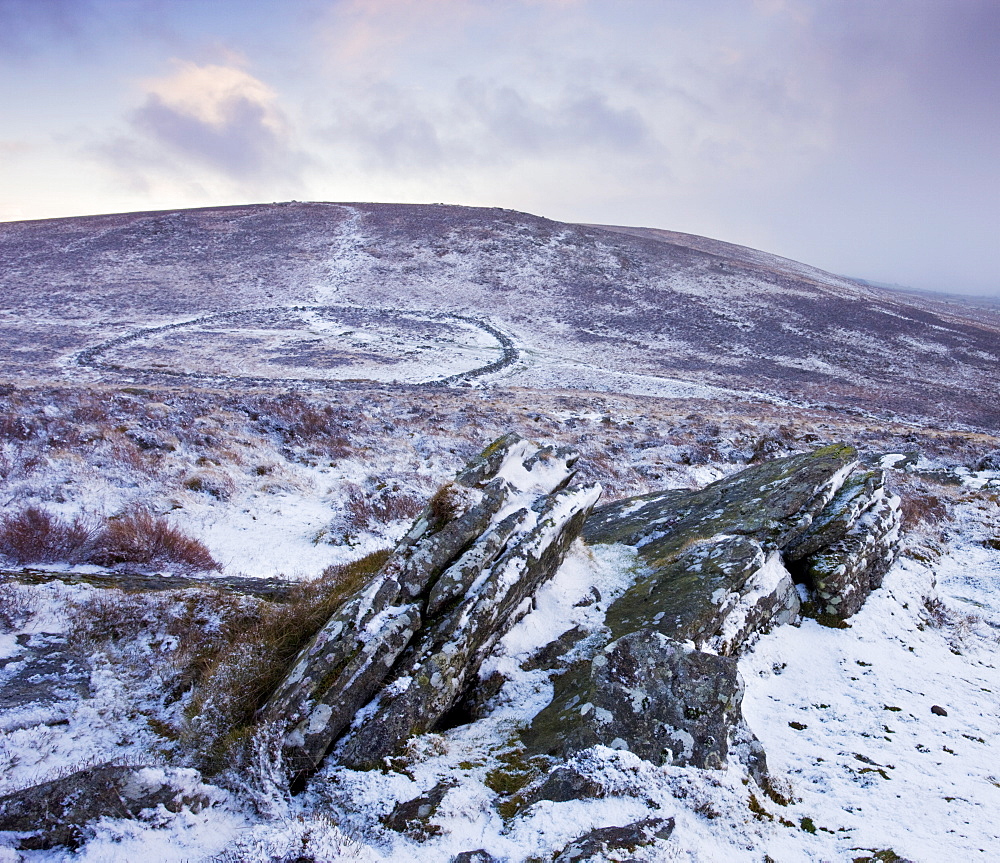 Snow covered rocky moorland landscape overlooking the Bronze Age walled settlement of Grimspound, Dartmoor National Park, Devon, England, United Kingdom, Europe