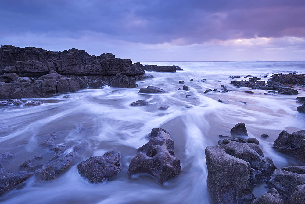 Sunset off the rugged coastline of Porthcawl on the Glamorgan coast in winter, Wales, United Kingdom, Europe