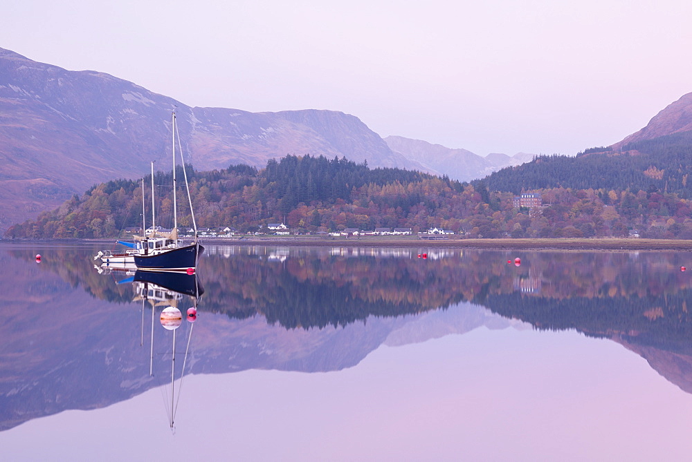 Yachts moored on a mirror still Loch Leven during twilight, Glencoe, Highland, Scotland, United Kingdom, Europe