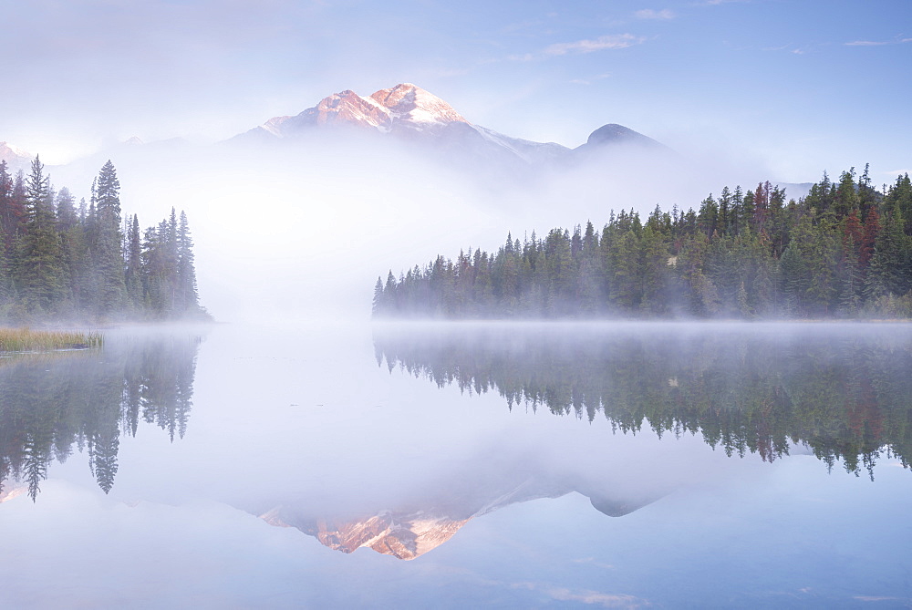 A mist shrouded Pyramid Mountain reflected in Pyramid Lake at dawn, Jasper National Park, UNESCO World Heritage Site, Alberta, Rocky Mountains, Canada, North America