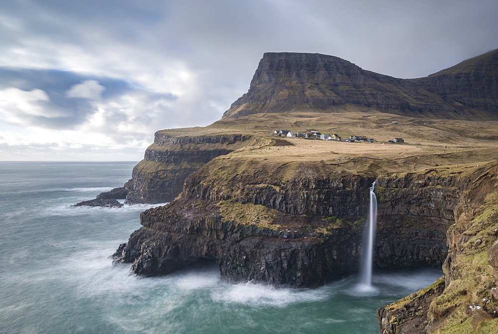 Dramatic coastal scenery near the village of Gasadalur on the island of Vagar in the Faroe Islands, Denmark, Europe