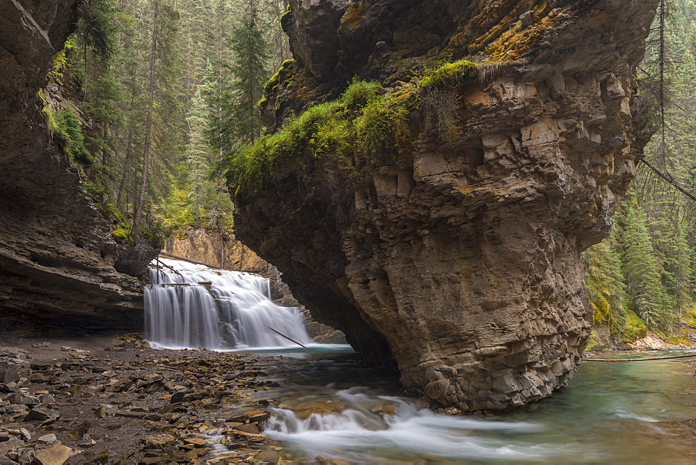 Waterfall at the base of a deep gorge at Johnston Canyon, Banff National Park, UNESCO World Heritage Site, Canadian Rockies, Alberta, Canada, North America