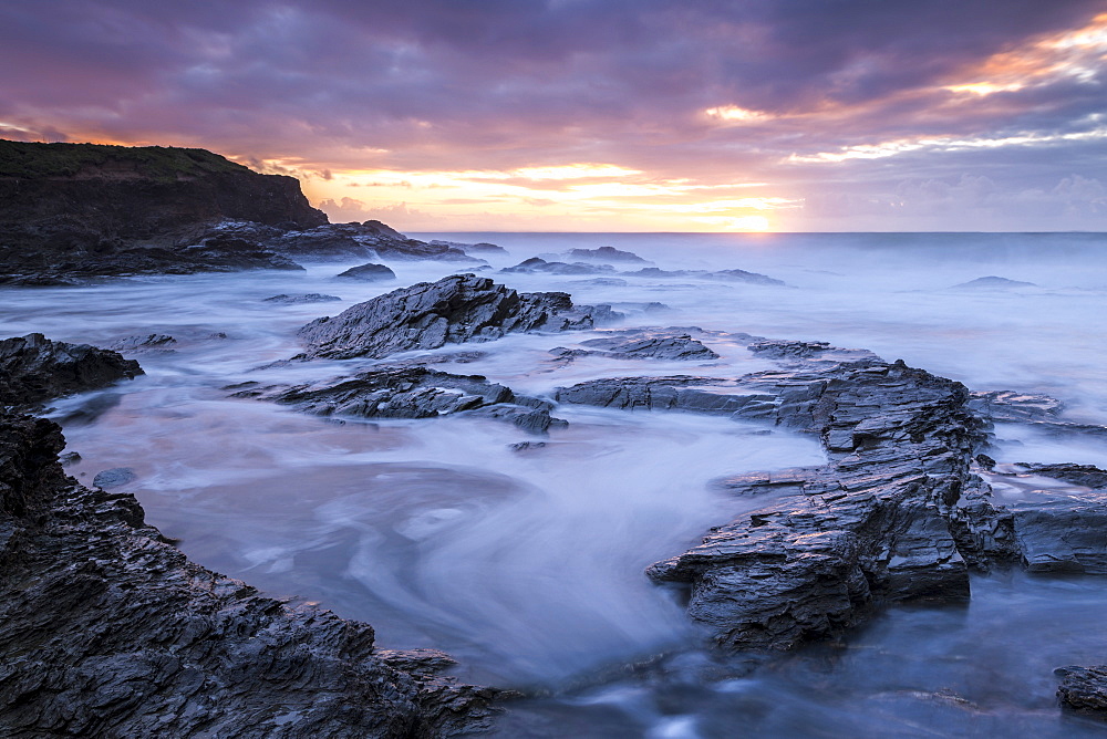 Sunset over the Atlantic from the rocky shores of Booby's Bay, Cornwall, England, United Kingdom, Europe