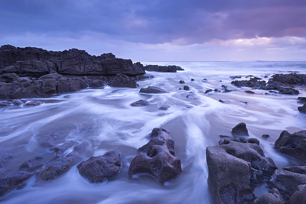 Sunset off the rugged coastline of Porthcawl on the Glamorgan coast, Wales, United Kingdom, Europe