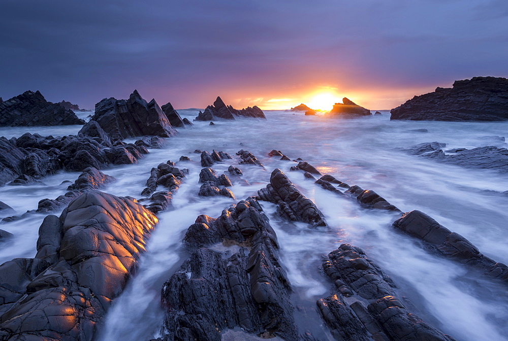 Dramatic sunset over the rocky ledges of Hartland Quay, Devon, England, United Kingdom, Europe