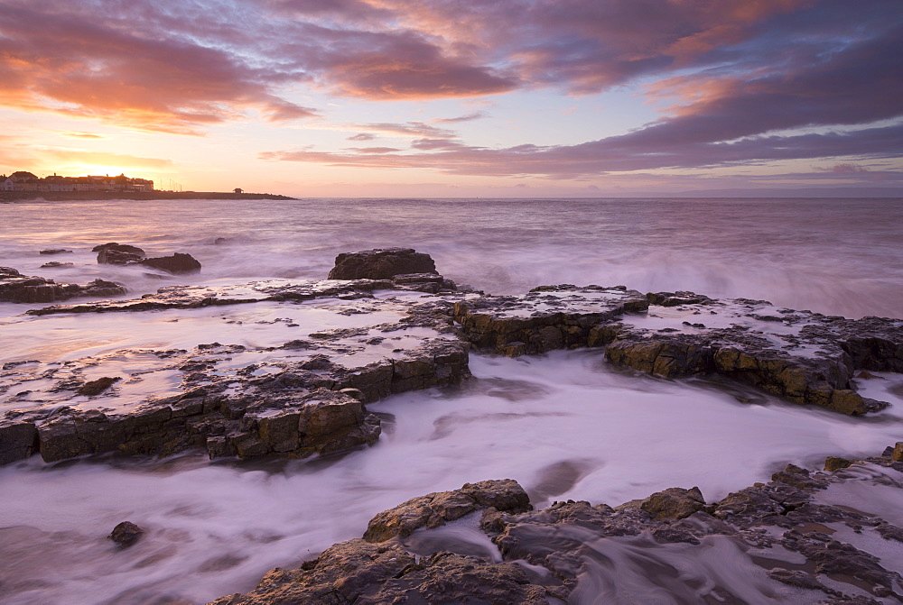 Colourful sunrise over the rocky shores of Porthcawl, Glamorgan, Wales, United Kingdom, Europe