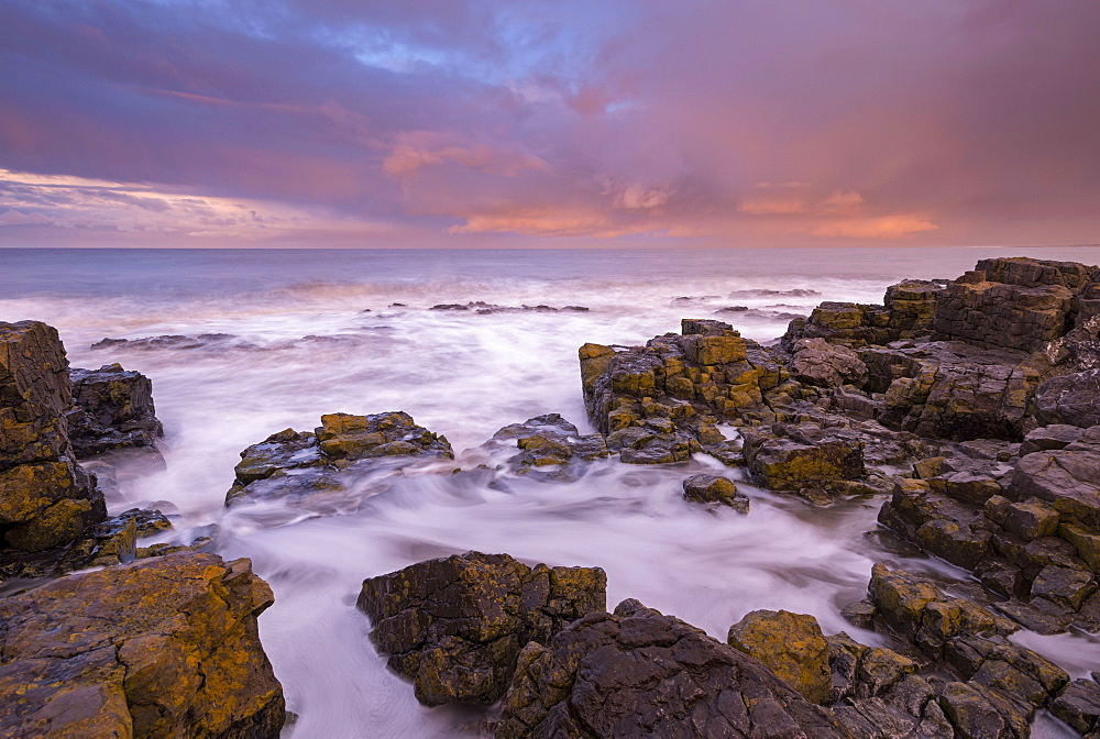 Waves crashing against rocks at sunrise in winter, Porthcawl, Glamorgan, Wales, United Kingdom, Europe