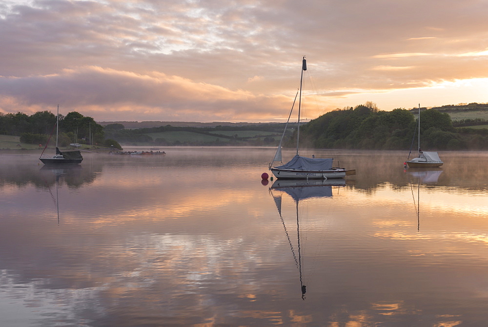 Boats on Wimbleball Reservoir on a beautiful misty morning at sunrise, Exmoor National Park, Somerset, England, United Kingdom, Europe