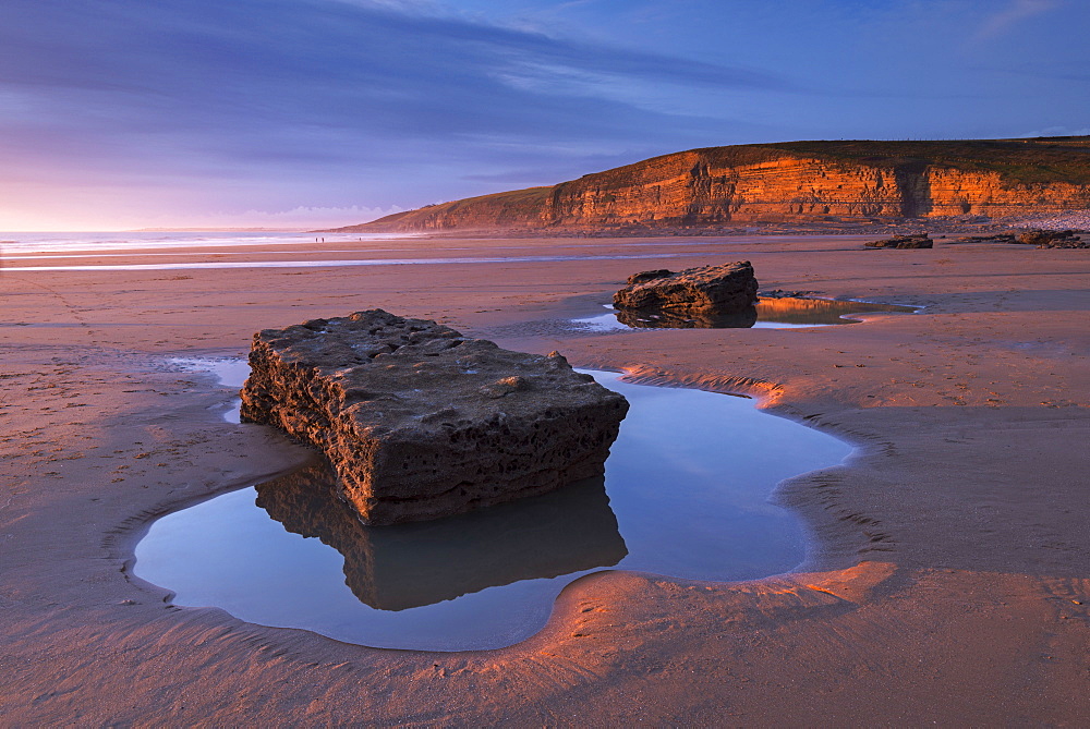 Winter light glows against the cliffs of Dunraven Bay on the Glamorgan Heritage Coast, Wales, United Kingdom, Europe