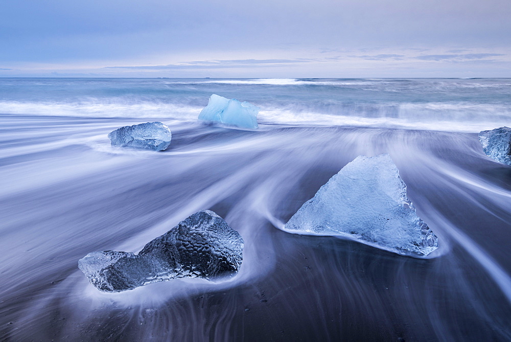 Icebergs washed ashore on the black sand beach at Jokulsarlon, Iceland, Polar Regions