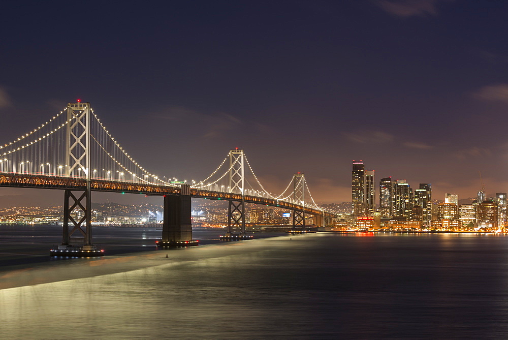 Night time cityscape of Oakland Bay Bridge and downtown San Francisco, California, United States of America, North America