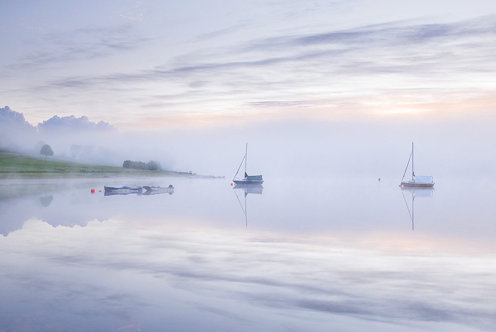 Sunrise on a misty morning on Wimbleball Reservoir, Exmoor National Park, Somerset, England, United Kingdom, Europe