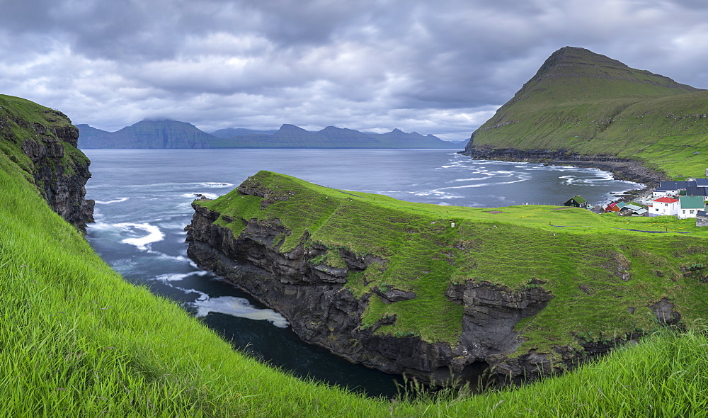 Cliff top view over the gorge at Gjogv towards the island of Kalsoy, Eysturoy, Faroe Islands, Denmark, Europe