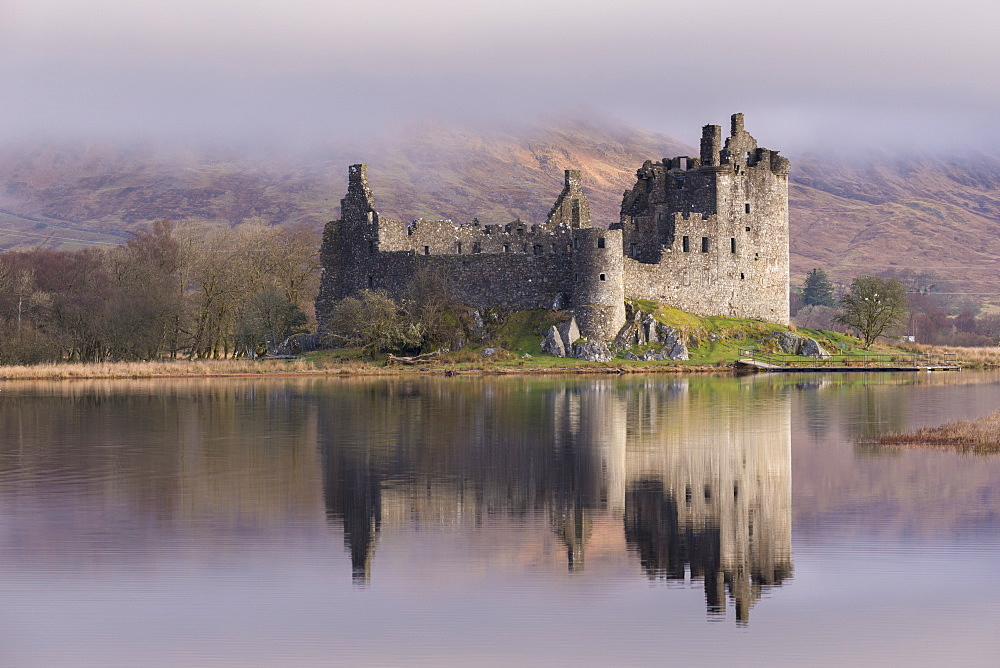 The ancient ruins of Kilchurn Castle, reflected in Loch Awe in winter, Dalmally, Argyll and Bute, Scotland, United Kingdom, Europe