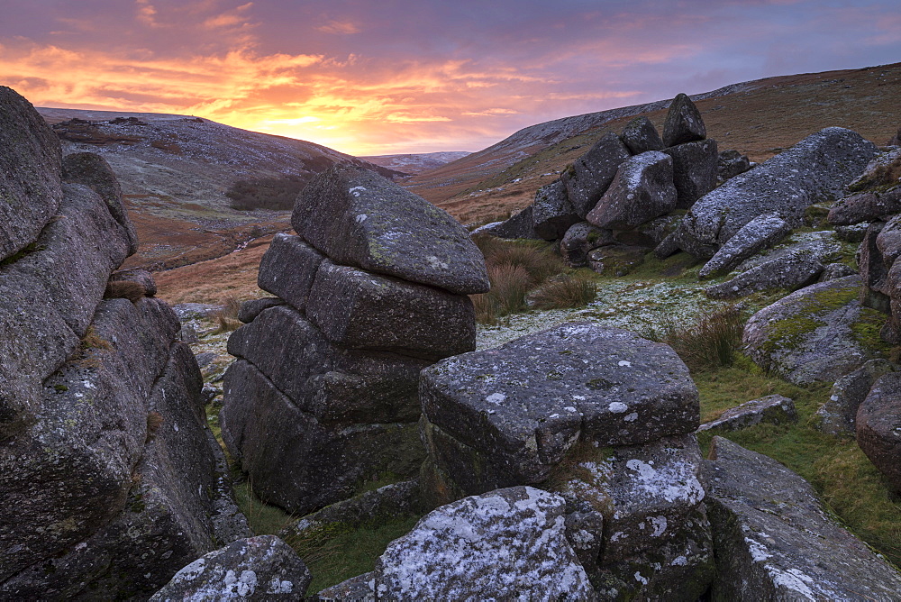 Beautiful sunrise behind a wintry Shelstone Tor in Dartmoor National Park, Devon, England, United Kingdom, Europe