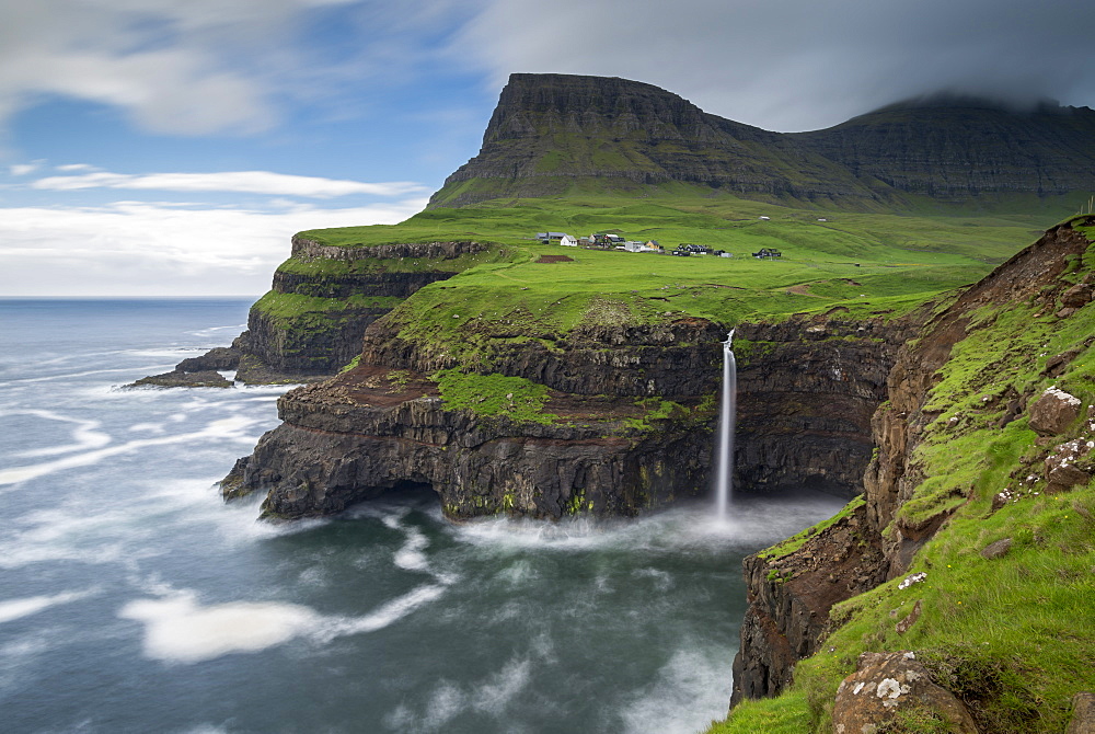 Waterfall cascading over cliffs at Gasadalur in the Faroe Islands, Denmark, Europe