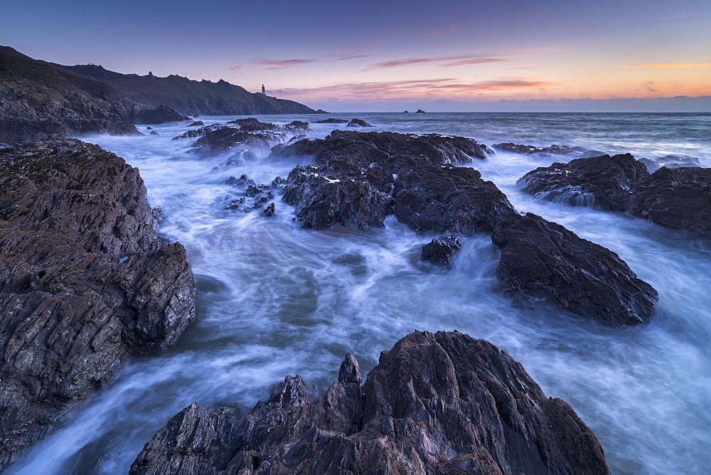 Waves swirl around the jagged rocks off Start Point in winter, South Hams, Devon, England, United Kingdom, Europe