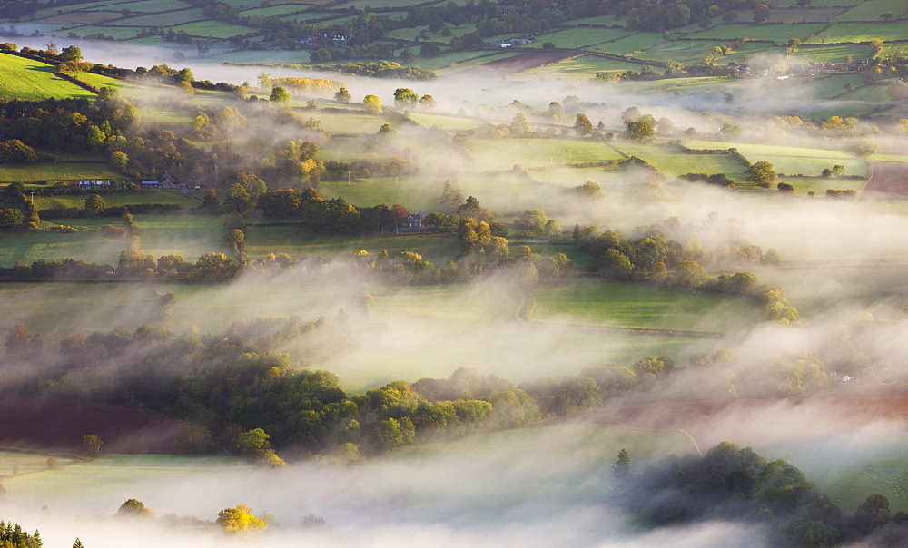 Mist blows over rolling countryside in the early morning near Talybont-on-Usk, Brecon Beacons National Park, Powys, Wales, United Kingdom, Europe