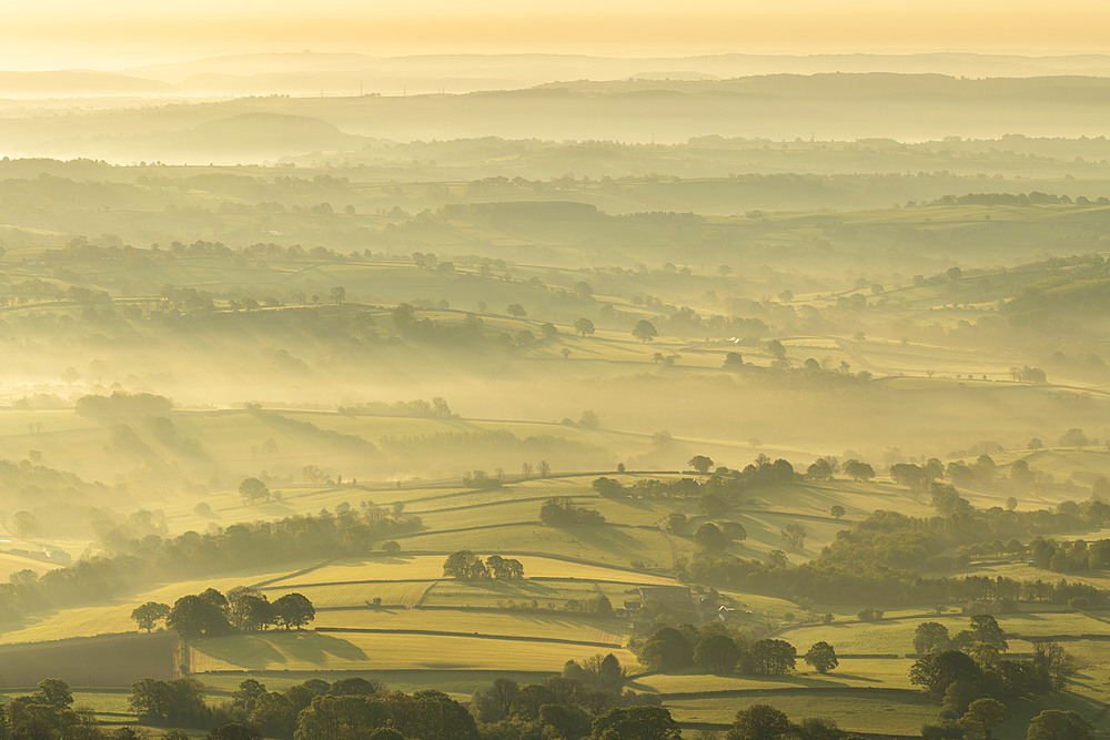 Mist covered rolling countryside at dawn, Abergavenny, Wales, United Kingdom, Europe