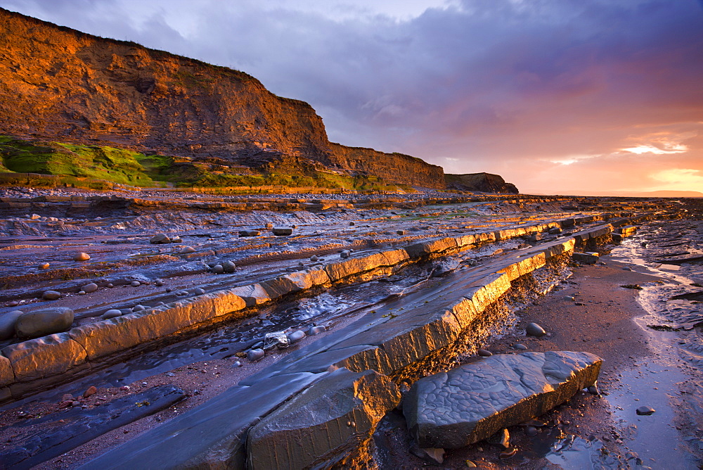 Late evening sunlight glows on the horizontal ledges of Kilve, Somerset, England, United Kingdom, Europe