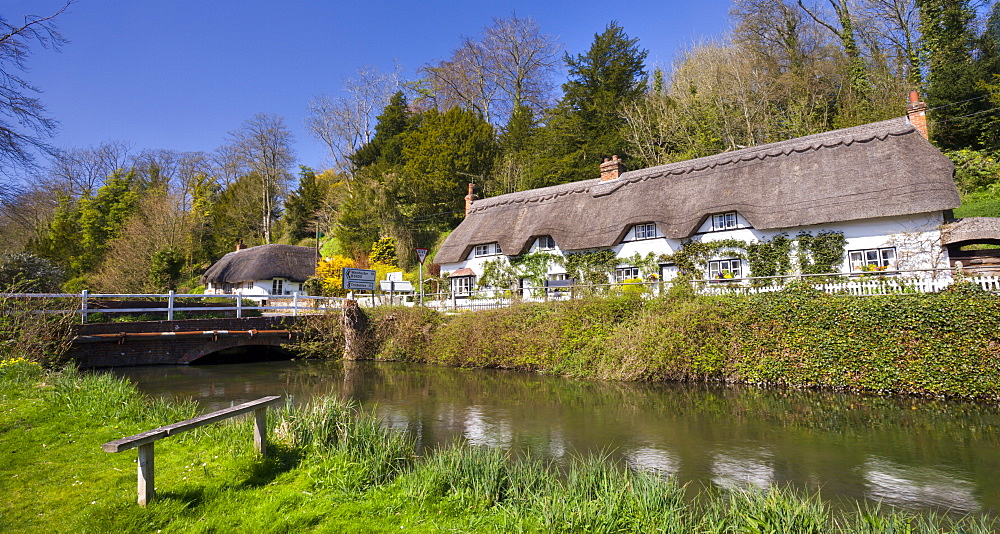 Thatched cottages beside the River Test at Wherwell, Hampshire, England, United Kingdom, Europe