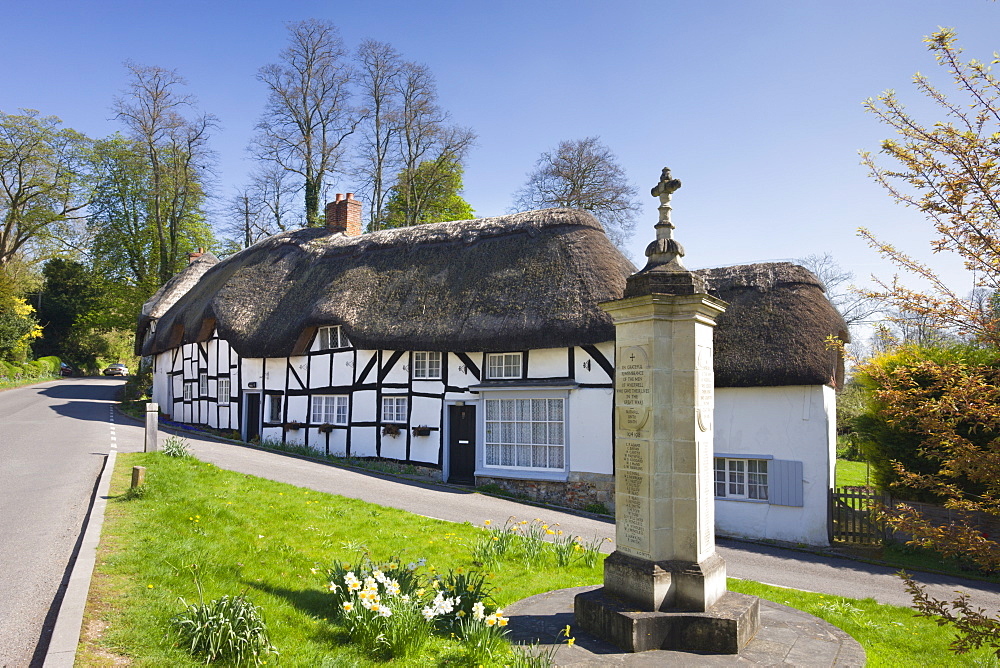 Thatched cottages and war memorial in the village of Wherwell, Hampshire, England, United Kingdom, Europe