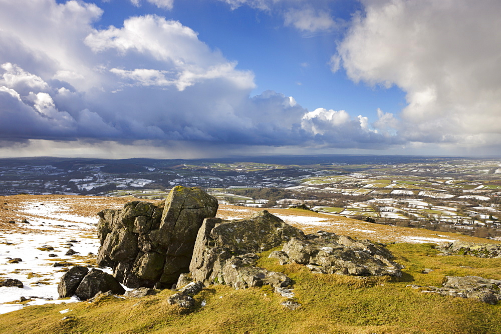 Sourton Tor backed by snow dusted countryside in winter, Dartmoor National Park, Devon, England, United Kingdom, Europe