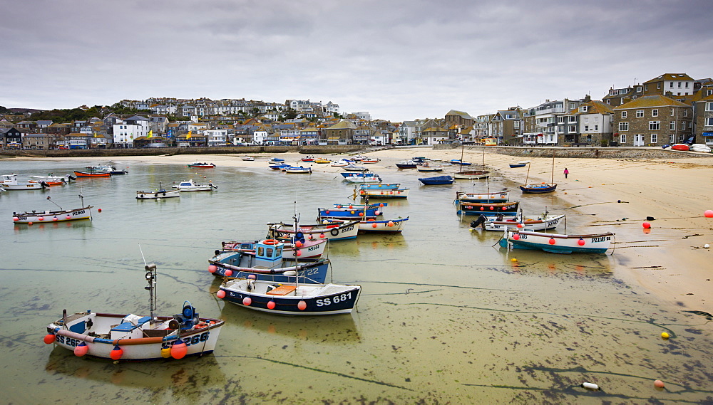 Fishing boats moored near the beach in St. Ives harbour, Cornwall, England, United Kingdom, Europe