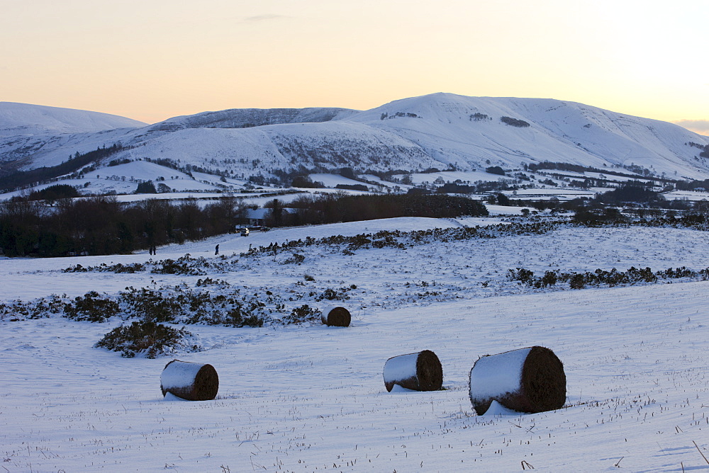 Snow covered bracken bales on Mynydd Illtud Common backed by snowy mountains, Brecon Beacons National Park, Powys, Wales, United Kingdom, Europe