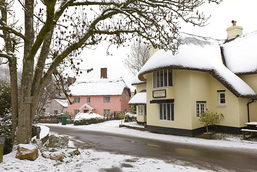 Snow covered country pub and cottages in the village of Winsford in winter, Exmoor National Park, Somerset, England, United Kingdom, Europe