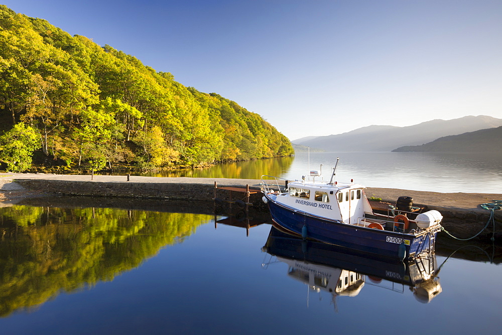 Boat moored in the small Inversnaid Hotel harbour on Loch Lomond, Loch Lomond and The Trossachs National Park, Stirling, Scotland, United Kingdom, Europe