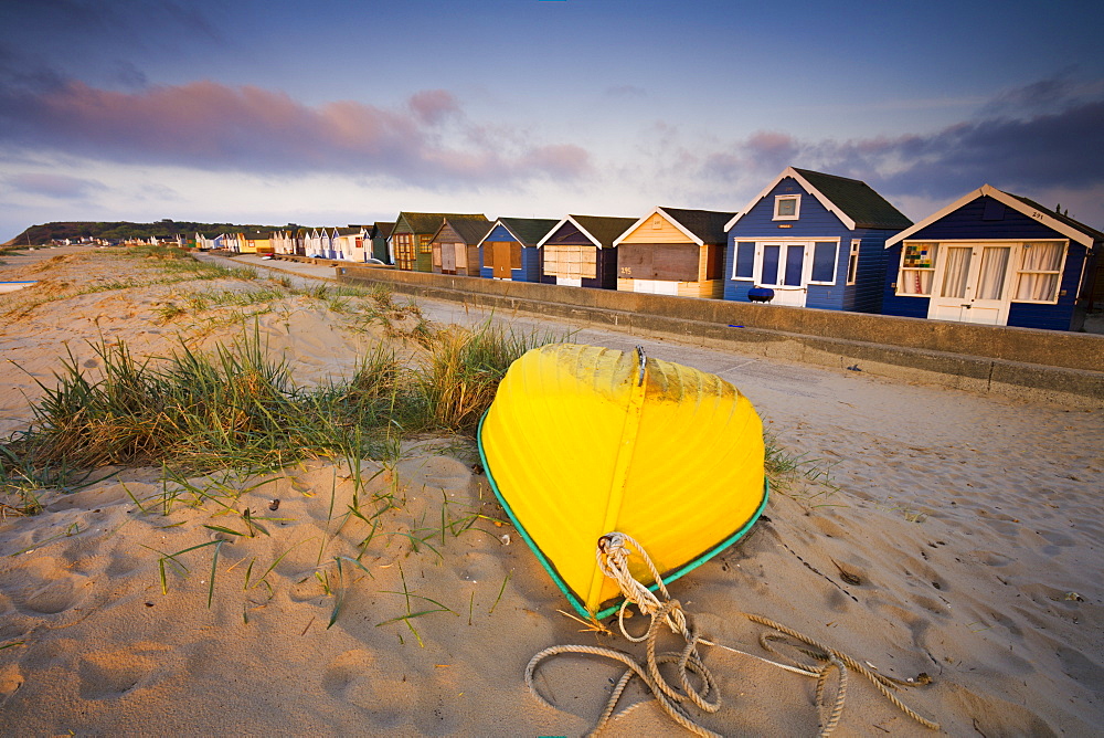 Beach huts and upturned boat at Hengistbury Head, Mudeford, Dorset, England, United Kingdom, Europe