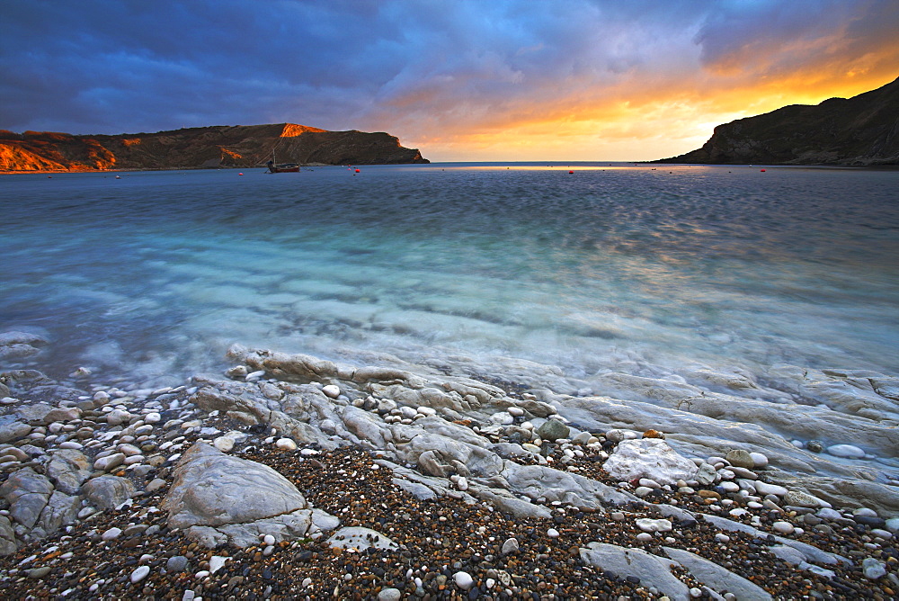 Sunset over the circular bay at Lulworth Cove, Jurassic Coast, UNESCO World Heritage Site, Dorset, England, United Kingdom, Europe