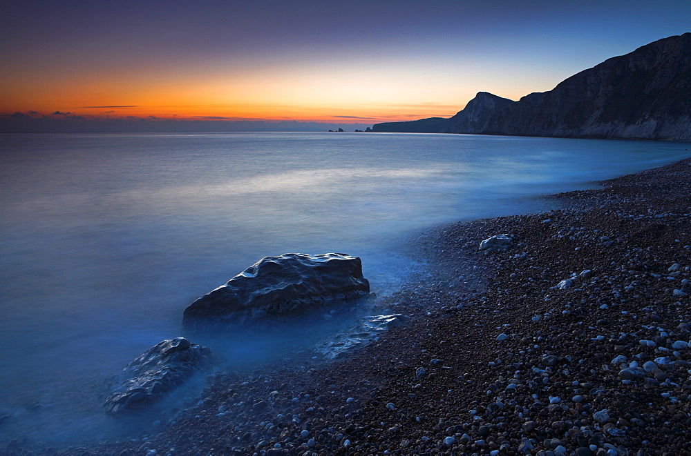 Twilight along the pebble shores of Worbarrow Bay, Jurassic Coast, UNESCO World Heritage Site, Dorset, England, United Kingdom, Europe