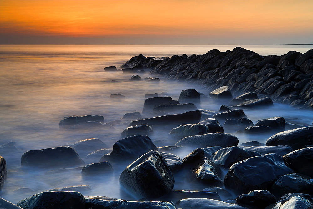 Misty water swirling around wet rocks at Kimmeridge Bay, Jurassic Coast, UNESCO World Heritage Site, Dorset, England, United Kingdom, Europe