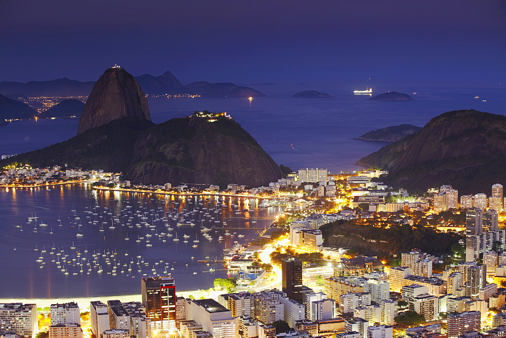 View of Sugar Loaf Mountain (Pao de Acucar) and Botafogo Bay at dusk, Rio de Janeiro, Brazil, South America 