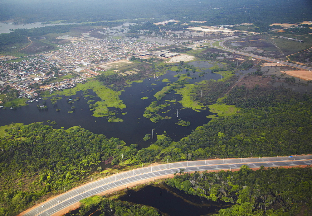 Aerial view of development encroaching on the Amazon rainforest and Rio Negro, Manaus, Amazonas, Brazil, South America 