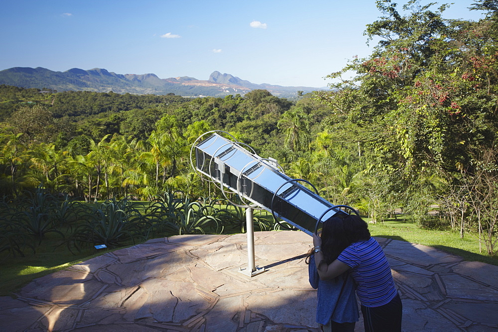 Couple looking though telescope by Olafur Eliasson at Centro de Arte Contemporanea Inhotim, Brumadinho, Belo Horizonte, Minas Gerais, Brazil, South America