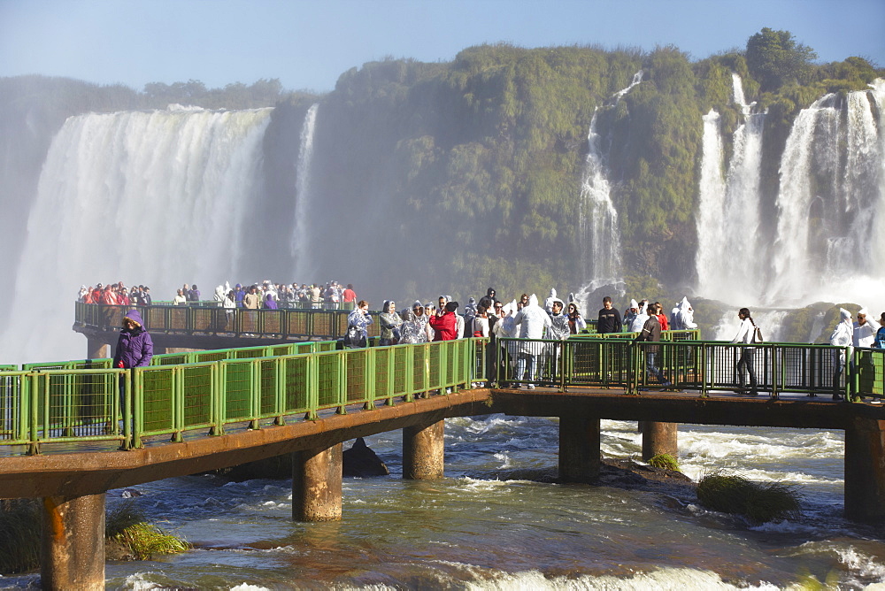 Tourists on walkway at Iguacu Falls, Iguacu National Park, UNESCO World Heritage Site, Parana, Brazil, South America