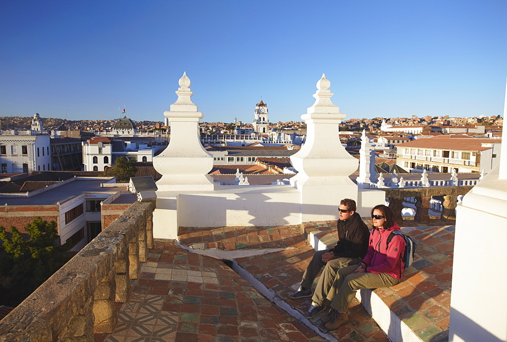 Couple sitting on rooftop of Convento de San Felipe Neri, Sucre, UNESCO World Heritage Site, Bolivia, South America