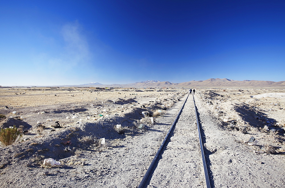 People walking along train tracks, Uyuni, Potosi Department, Bolivia, South America