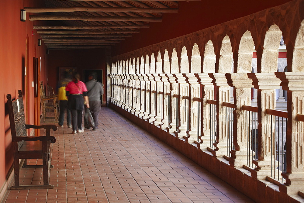 People walking along corridor of San Francisco Museum inside San Francisco Church, La Paz, Bolivia, South America