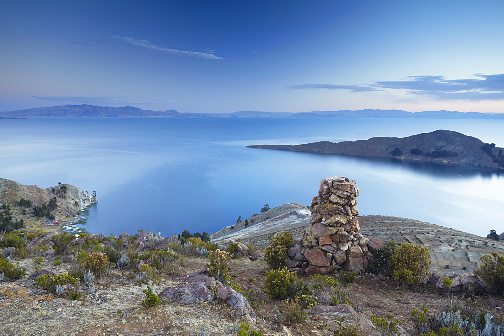 Stack of prayer stones on Isla del Sol (Island of the Sun) at sunset, Lake Titicaca, Bolivia, South America