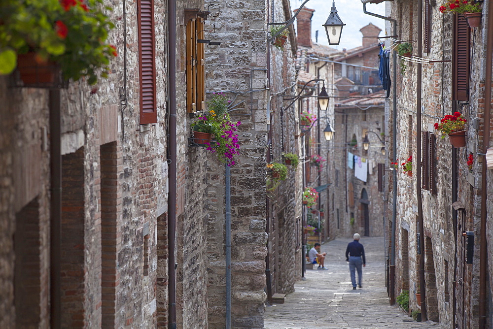 Man walking along Via Aquilante, Gubbio, Umbria, Italy, Europe