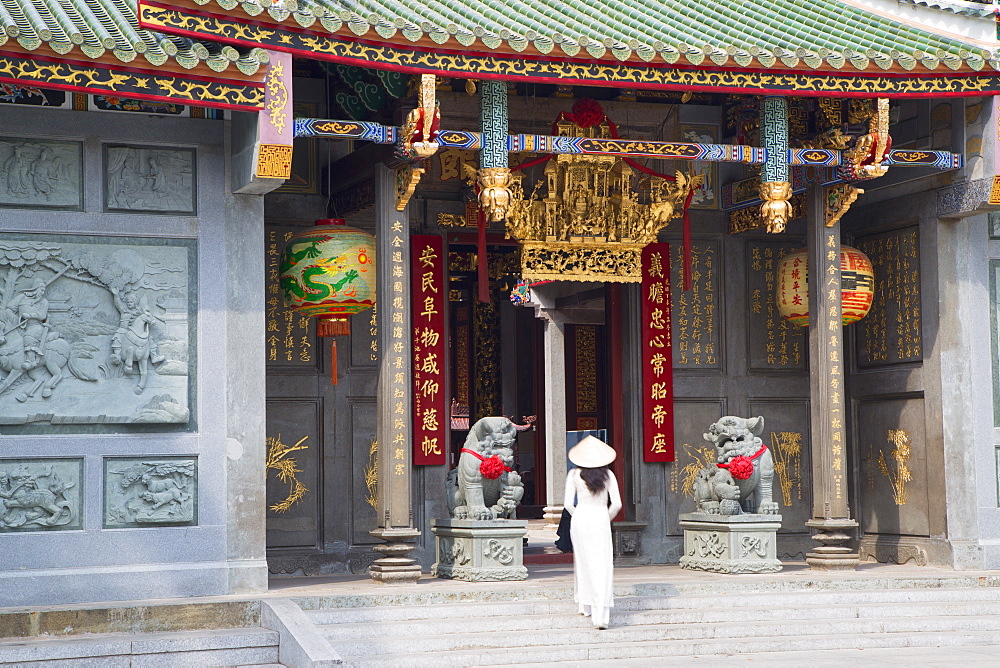 Woman wearing ao dai dress at Nghia An Hoi Quan Pagoda, Cholon, Ho Chi Minh City, Vietnam, Indochina, Southeast Asia, Asia