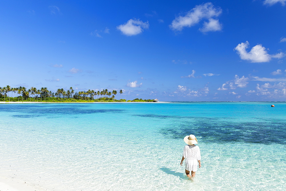 Woman on beach at Olhuveli Beach and Spa Resort, South Male Atoll, Kaafu Atoll, Maldives, Indian Ocean, Asia