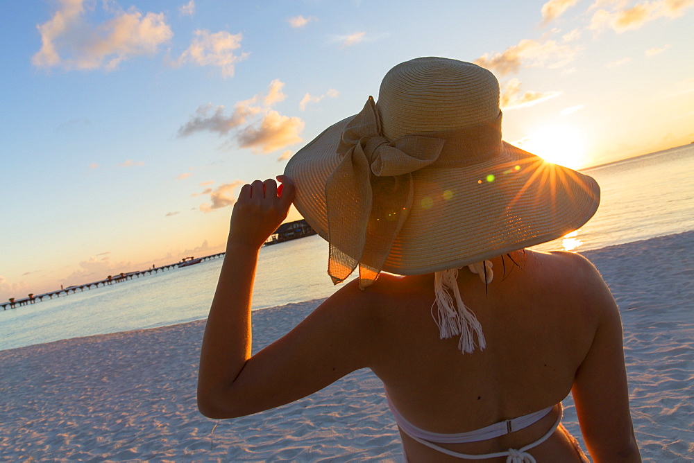 Woman on beach at Olhuveli Beach and Spa Resort, South Male Atoll, Kaafu Atoll, Maldives, Indian Ocean, Asia