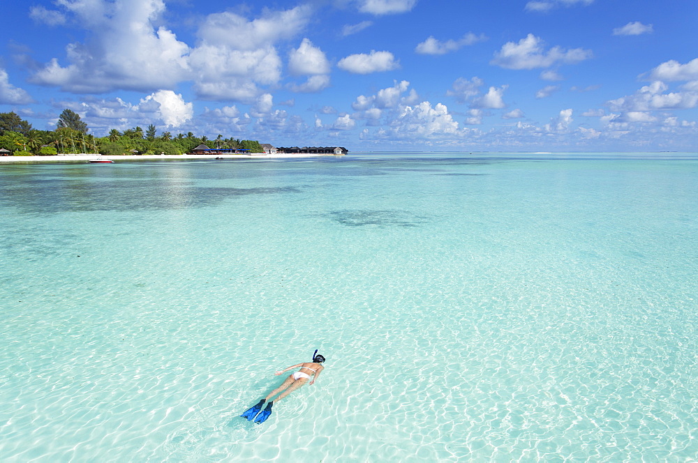 Woman snorkelling at Olhuveli Beach and Spa Resort, South Male Atoll, Kaafu Atoll, Maldives, Indian Ocean, Asia